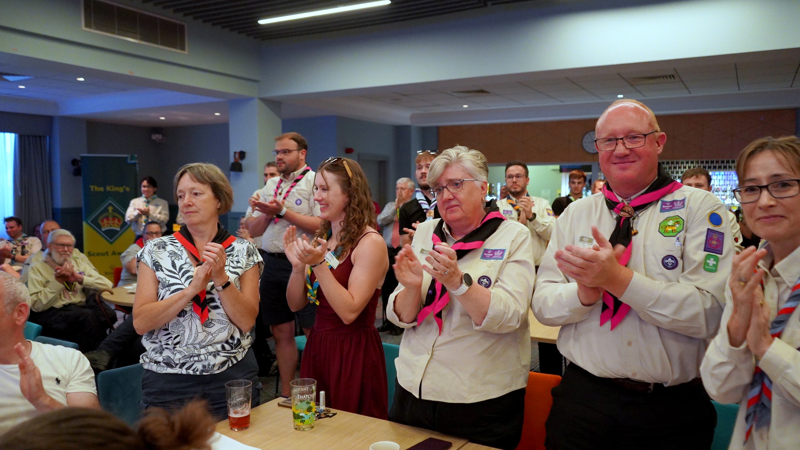 Delegates across the hall stand and applaud the award winners.